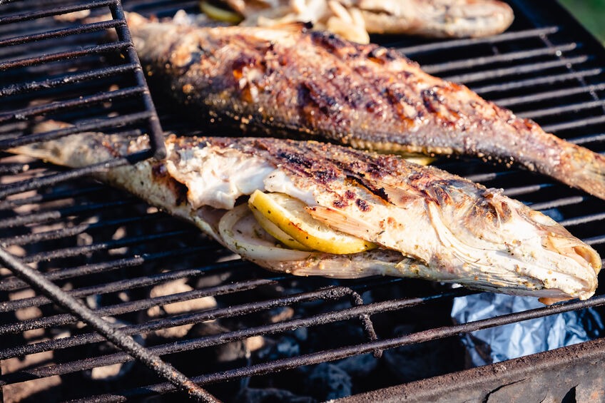 Fish grilling with lemon