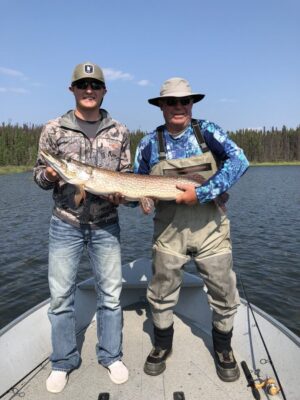 2 Men Holding Northern Pike caught in Reindeer Lake