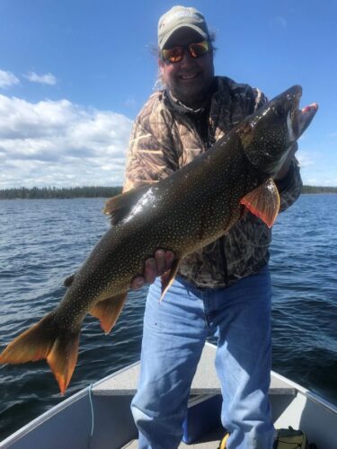 Man with Large Fish on Reindeer Lake