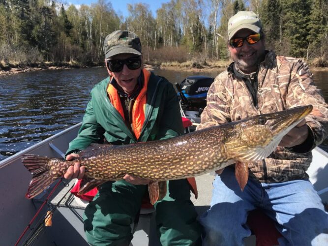 Men Happy with Large Fish Caught in Lake